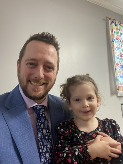 Joel Loughrin, founder of Strategrow, smiling with his daughter before heading to an event.